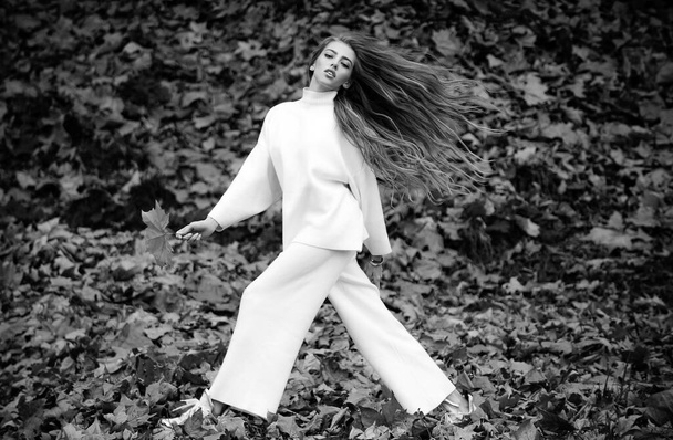 Autumn woman in urban park smiling happy, full length in motion. Autumnal vogue - Foto, Imagen