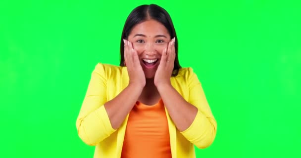 Green screen, wow and hands on woman face in studio with bonus, news or promotion, sale or discount on mockup background. Portrait, smile and excited asian lady winner celebrating coming soon deal. - Footage, Video