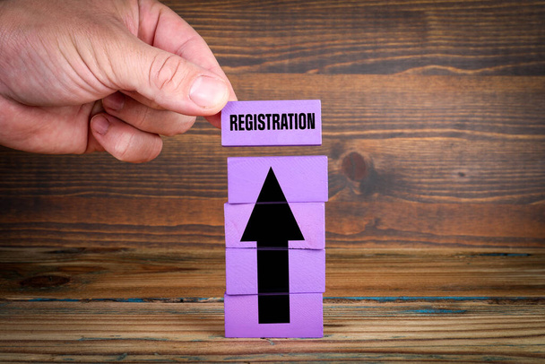 REGISTRATION Concept. Colorful blocks on a wooden background. - Photo, Image