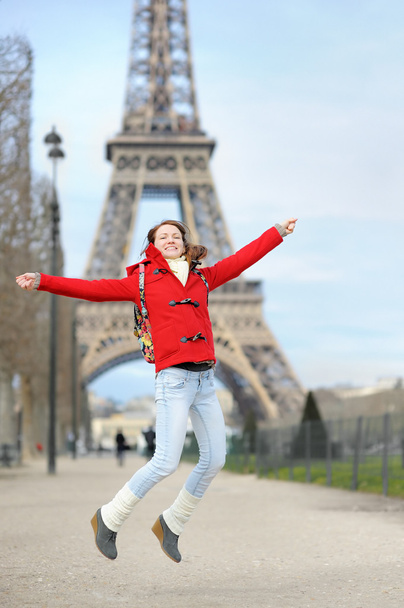 Young woman having fun near the Eiffel tower - Fotoğraf, Görsel