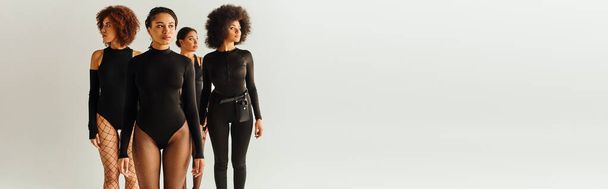 attractive young african american female friends in black appealing bodysuits, fashion, banner - Photo, Image