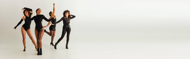 Seksi vücutlu neşeli Afro-Amerikan bayan arkadaşları mutlu bir şekilde dans ediyor, moda konsepti, afiş - Fotoğraf, Görsel