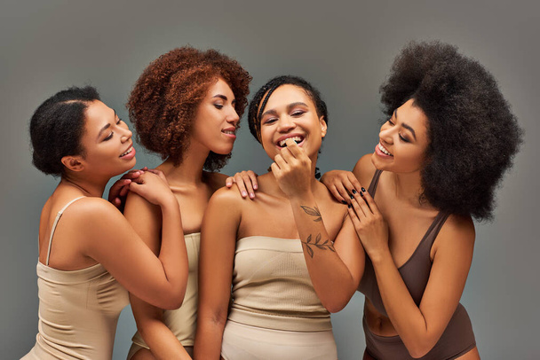 beautiful cheerful african american women in underwear having great time together, fashion concept - Photo, Image
