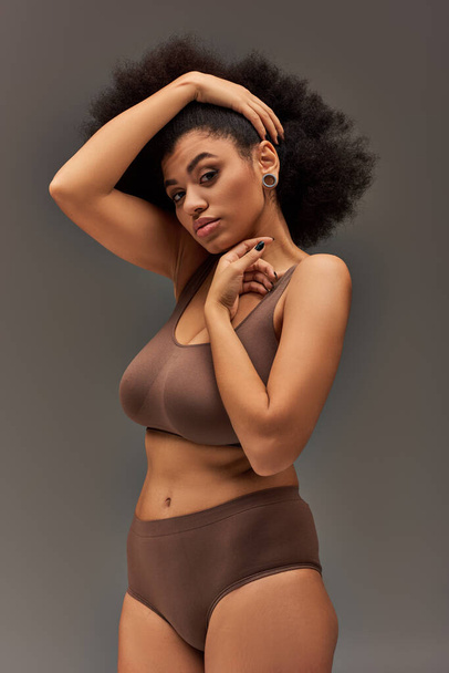 young african american woman in pastel underwear with black nail polish posing alluringly, fashion - Photo, Image