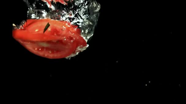 Sliced tomatoes fall under water. Filmed on a high-speed camera at 1000 fps. High quality FullHD footage - Metraje, vídeo