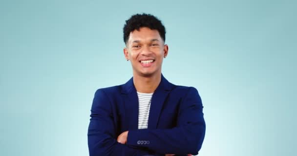 Corporate, crossed arms and portrait of businessman in studio confident for career, job and startup with smile. Professional, fashion and person with confidence, pride and ambition on blue background. - Footage, Video