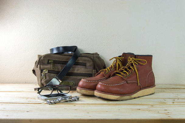 Still life with casual man, boots and bag on wooden table backgr - Photo, Image