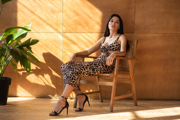 Woman in leopard print summer dress - Photo, Image