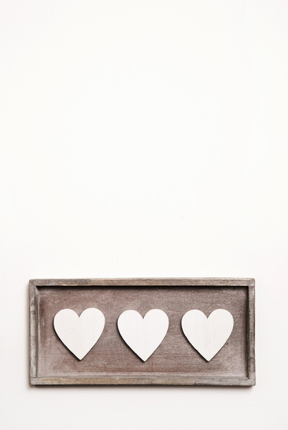 White wooden vintage background with three hearts. - Photo, Image