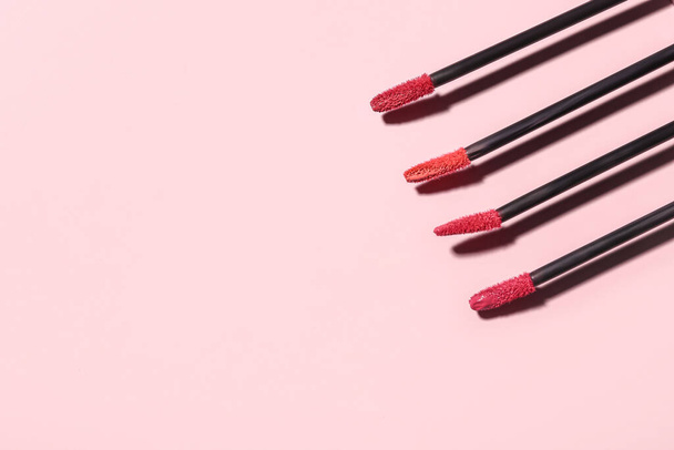Different lipstick brushes on pink background - Photo, Image