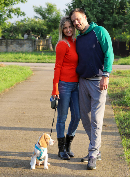 happy family walking in the autumn park with dog - Foto, imagen