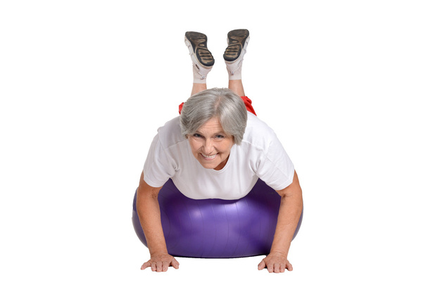 Senior woman exercising with ball - Foto, afbeelding