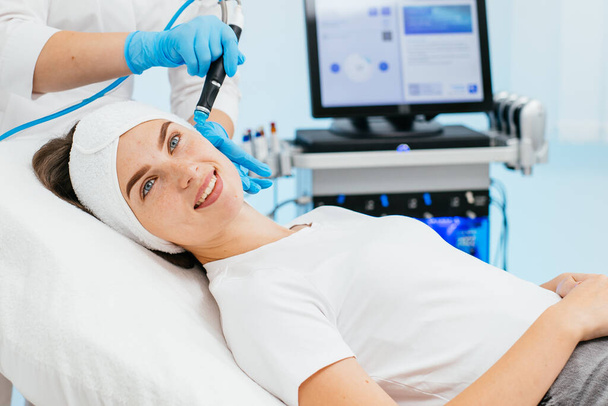 Face Skin Care. Close-up Of Woman Getting Facial Hydro Microdermabrasion Peeling Treatment At Cosmetic Beauty Spa Clinic. Hydra Vacuum Cleaner. Exfoliation, Rejuvenation And Hydratation. Cosmetology. - Photo, Image
