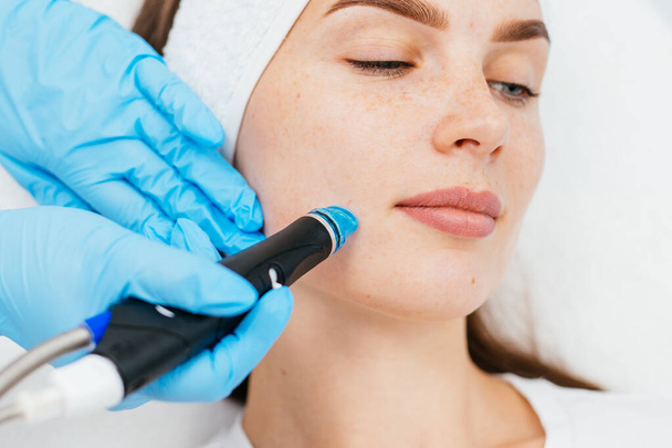 Face Skin Care. Close-up Of Woman Getting Facial Hydro Microdermabrasion Peeling Treatment At Cosmetic Beauty Spa Clinic. Hydra Vacuum Cleaner. Exfoliation, Rejuvenation And Hydratation. Cosmetology. - Photo, Image