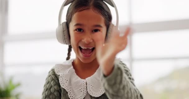 Girl child, wave and video call for online class, smile or face for education, communication or respect. Kid, portrait and headphones with greeting, kindness or happy for webinar, elearning or school. - Footage, Video