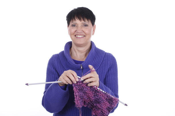 Elder woman with knitting - 写真・画像