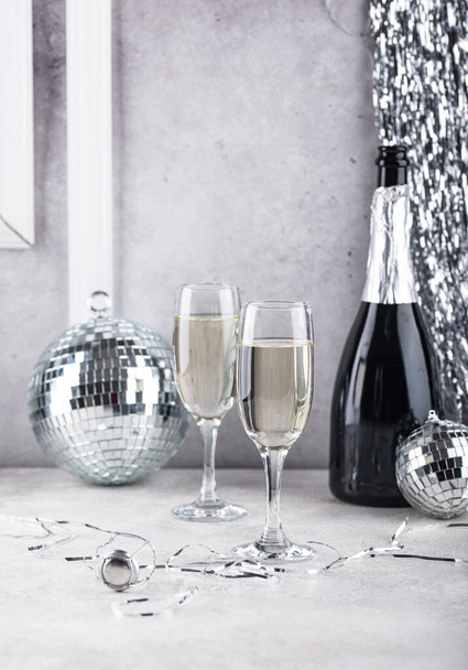 Glass of champagne with silver mirror disco ball. New year party composition - Foto, Bild