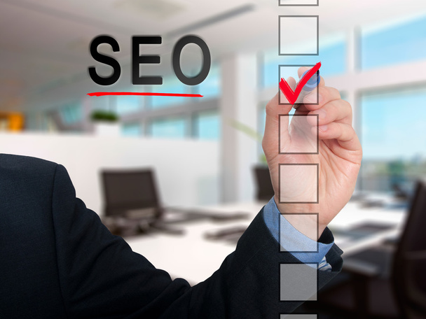 Businessman checking mark on SEO checklist marker. Checking SEO. Isolated on  background, Stock Photo - Fotó, kép