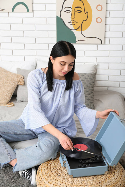 Young woman with record player in bedroom - Photo, Image