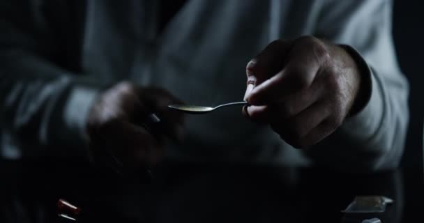 Drugs, hands and syringe, lighter and spoon in studio isolated on a black background. Drug addiction, teaspoon and man with fire, person and junkie cooking dose of heroin, crack or cocaine for crime. - Filmmaterial, Video