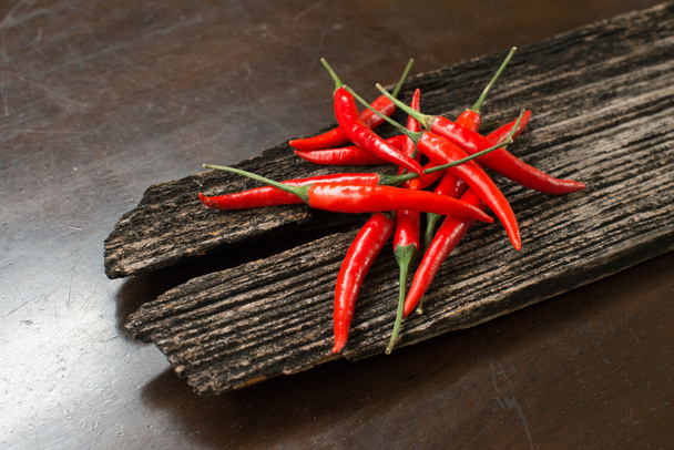 Red chillies on a plank - Fotó, kép