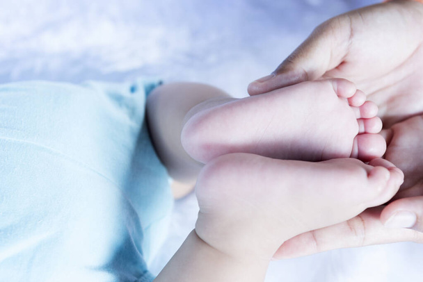 Pies de bebé en la mano, madre, diminutos pies de bebé recién nacidos en la mano, foto femenina, primer plano, madre y su hijo, concepto de familia feliz, hermosa imagen concepto de parto. - Foto, imagen
