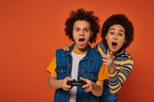 loving african american brother and sister playing video games with joystick, family concept - Foto, Imagem