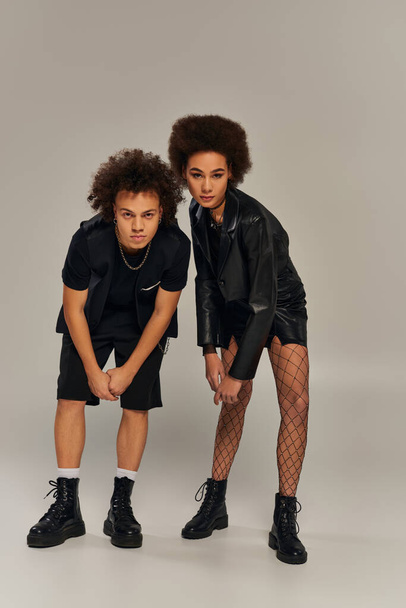 attractive stylish african american siblings in fashionable outfits posing actively together - Photo, Image