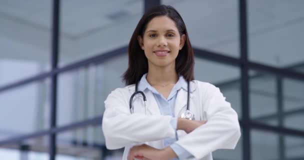 Doctor, arms crossed and face of happy woman in a hospital for help, service or advice. Healthcare, pride and portrait of proud female intern at medical clinic for consulting, treatment or checkup. - Footage, Video