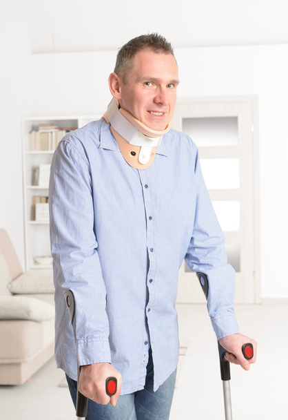 Man with crutches and crevical collar - Photo, Image