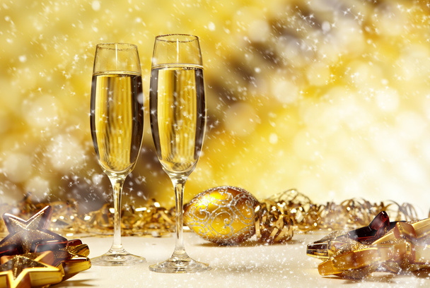Glass of champagne against golden background - Photo, image