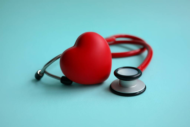 Red stethoscope with heart on blue modern background. Medical insurance concept - Photo, Image