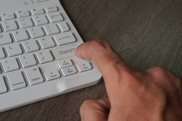Imagen de cerca de la mano presionando la etiqueta del teclado con ChatGPT.  - Foto, Imagen
