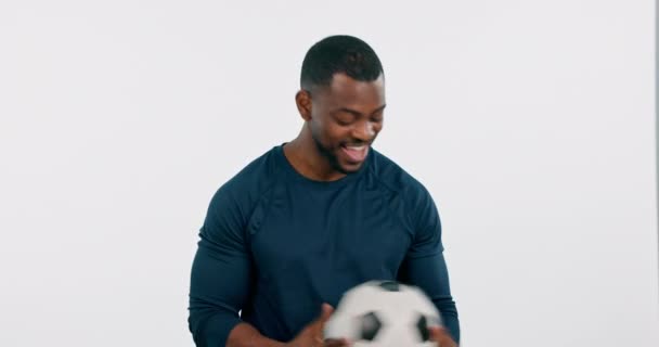 Face, football and happy black man in studio for workout, training or exercise. Portrait, soccer and athlete smile for sports, fitness and healthy body isolated on a white background mockup space. - Footage, Video