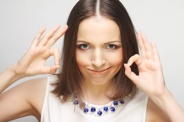 Successful girl gives thumb up with two hands - Foto, Bild