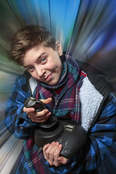 concentrated teenage boy with joy-stick with motion blur backgro - Photo, Image