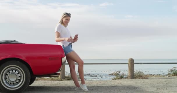 Woman, smile and selfie by car on road trip to beach, ocean or seaside for vacation. Person, laugh or happy with technology for communication, connectivity or social media by internet, web or app. - Footage, Video