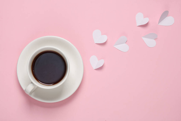 Kopje thee of koffie met hartjes op een roze achtergrond. Bovenaanzicht - Foto, afbeelding