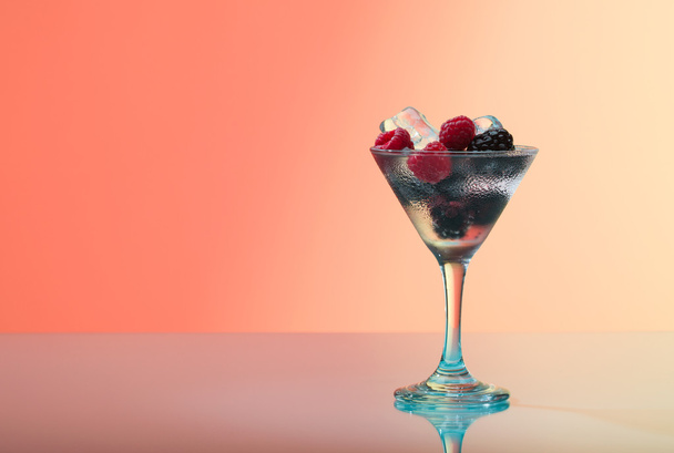 Refreshing raspberry and blackberry cocktail with ice, studio shot - Zdjęcie, obraz