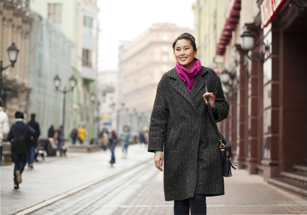 Young Asian woman walking on spring city in Russia - Foto, imagen