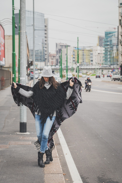 Beautiful young brunette posing in the city streets - 写真・画像