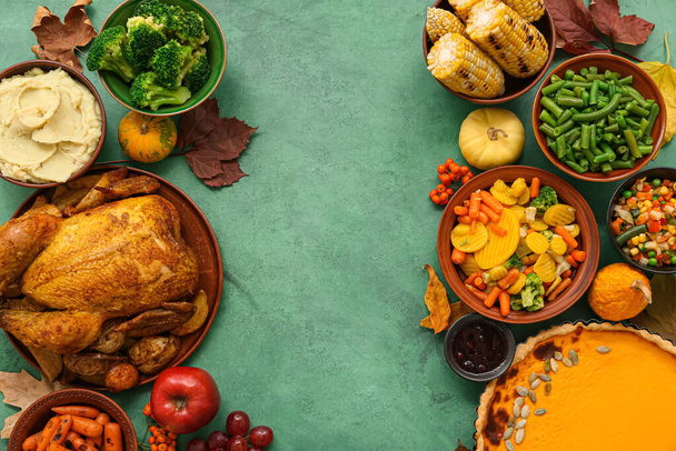 Frame made of festive dishes for Thanksgiving Day on green background - Photo, Image