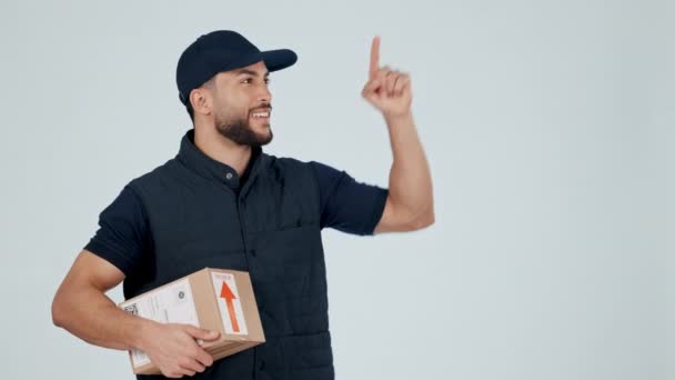 Delivery man, pointing at supplier list and package, OK with service information and advertising on white background. Box, supply chain and e commerce with courier choice and distribution in studio. - Footage, Video