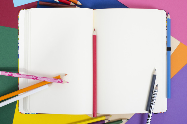 Blank notebook with color pencils. - Фото, изображение
