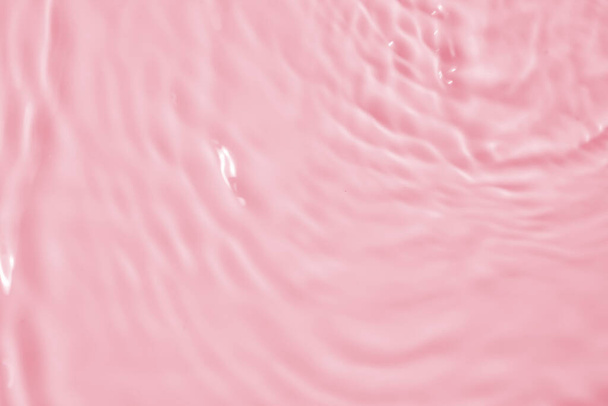 Abstract transparent water shadow surface texture natural ripple on pink background - Photo, Image