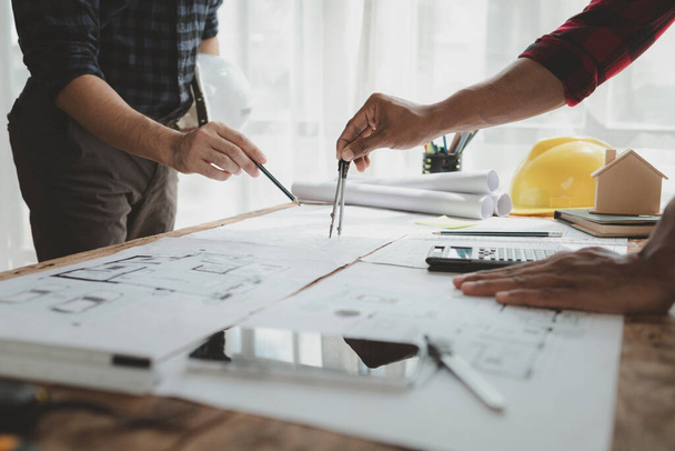 engineer is in planning meeting with architect about building a house,  Draw structural of buildings at the meeting and discuss together,  Design blueprints for use in structural work, architect idea. - Photo, Image