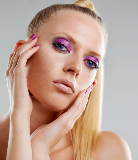 Beauty, makeup and art, portrait of woman in studio with neon eye shadow, creative facial and luxury skincare. Fashion, purple cosmetics and face of model with unique aesthetic on white background - Photo, Image