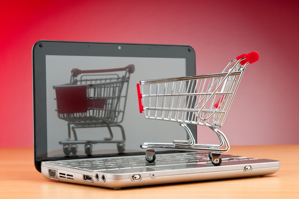 Internet online shopping concept with computer and cart - Foto, imagen