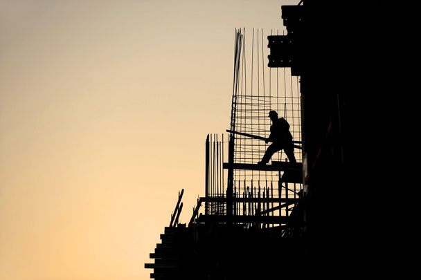 Construction worker silhouette at sunset - Photo, Image