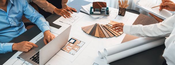 Group of interior designer team in meeting, discussing with engineer on interior design and planning for house project blueprint and model, choosing color sample and mood board materials. Insight - Photo, Image